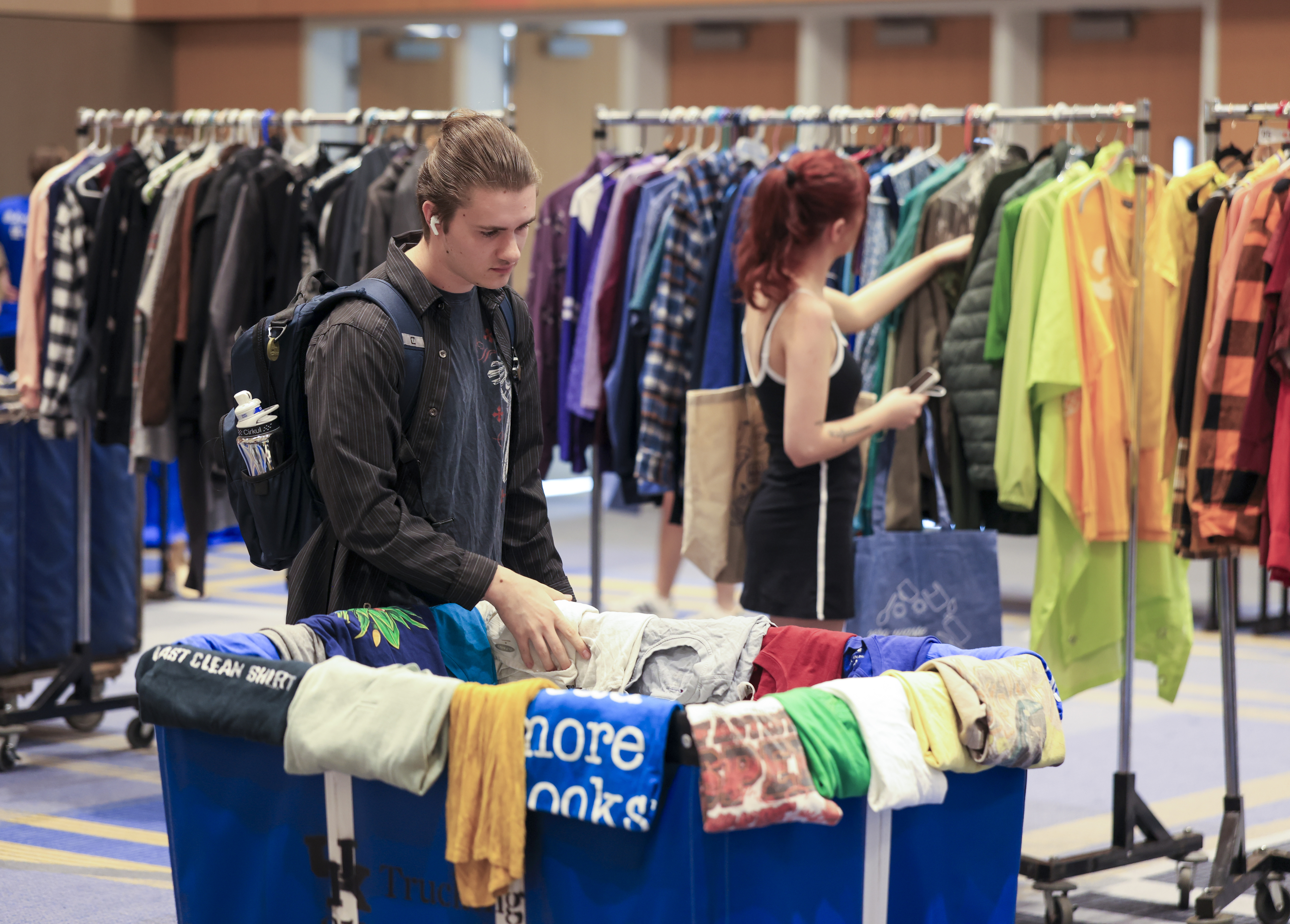 Students looking at clothes at the Thrift Shop Pop Up