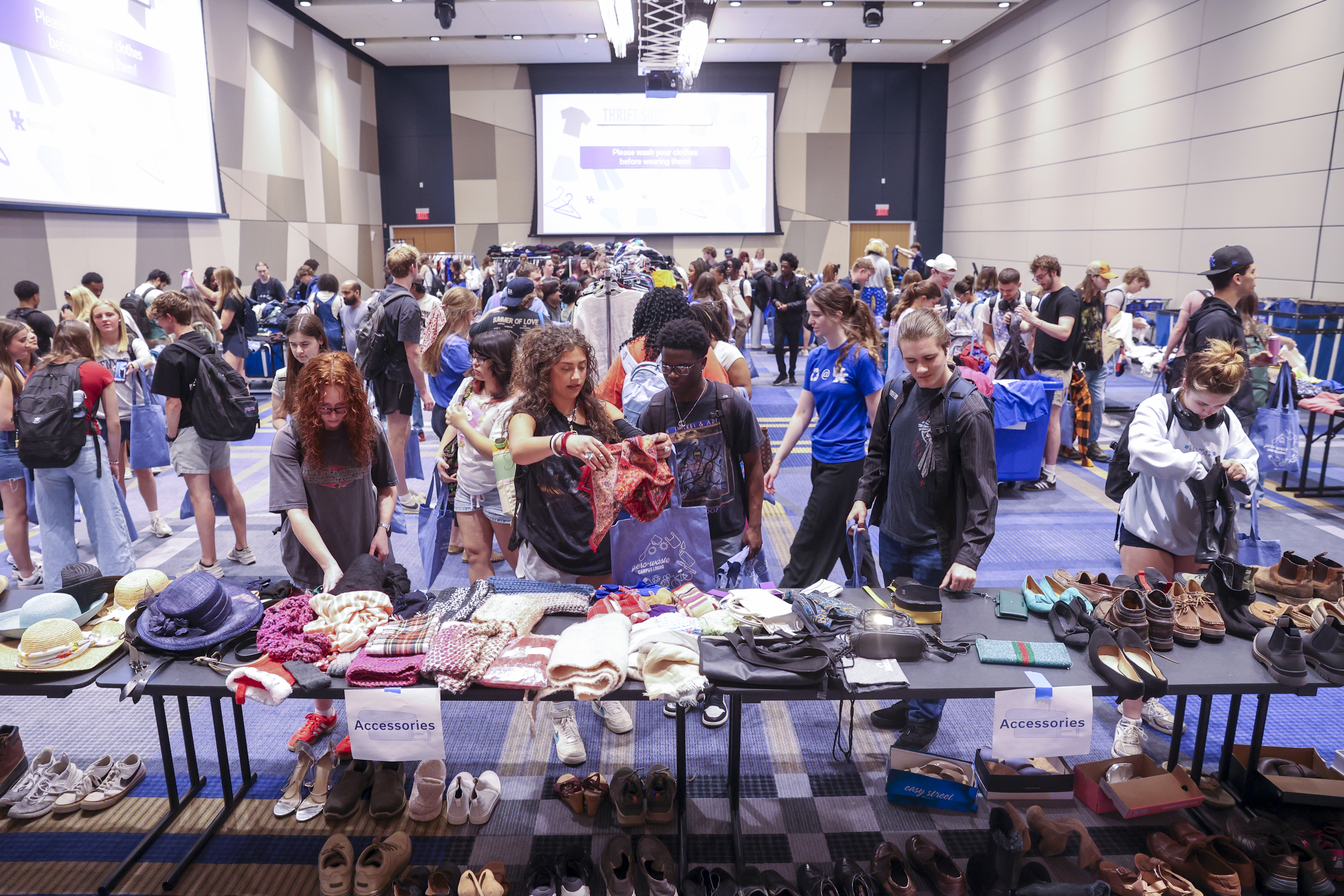 Students looking at clothes at the Thrift Shop Pop Up