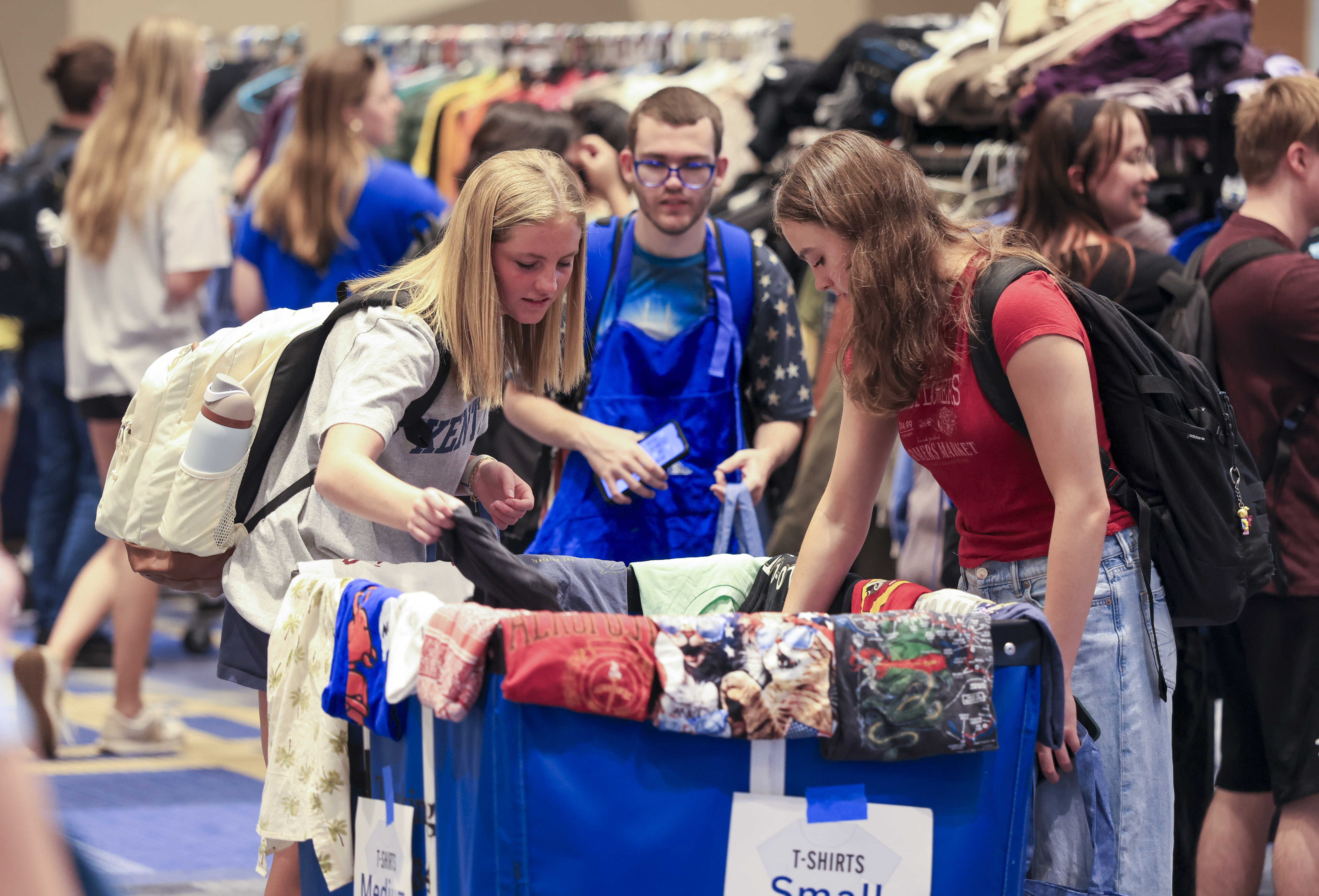 Students looking at clothes at the Thrift Shop Pop Up