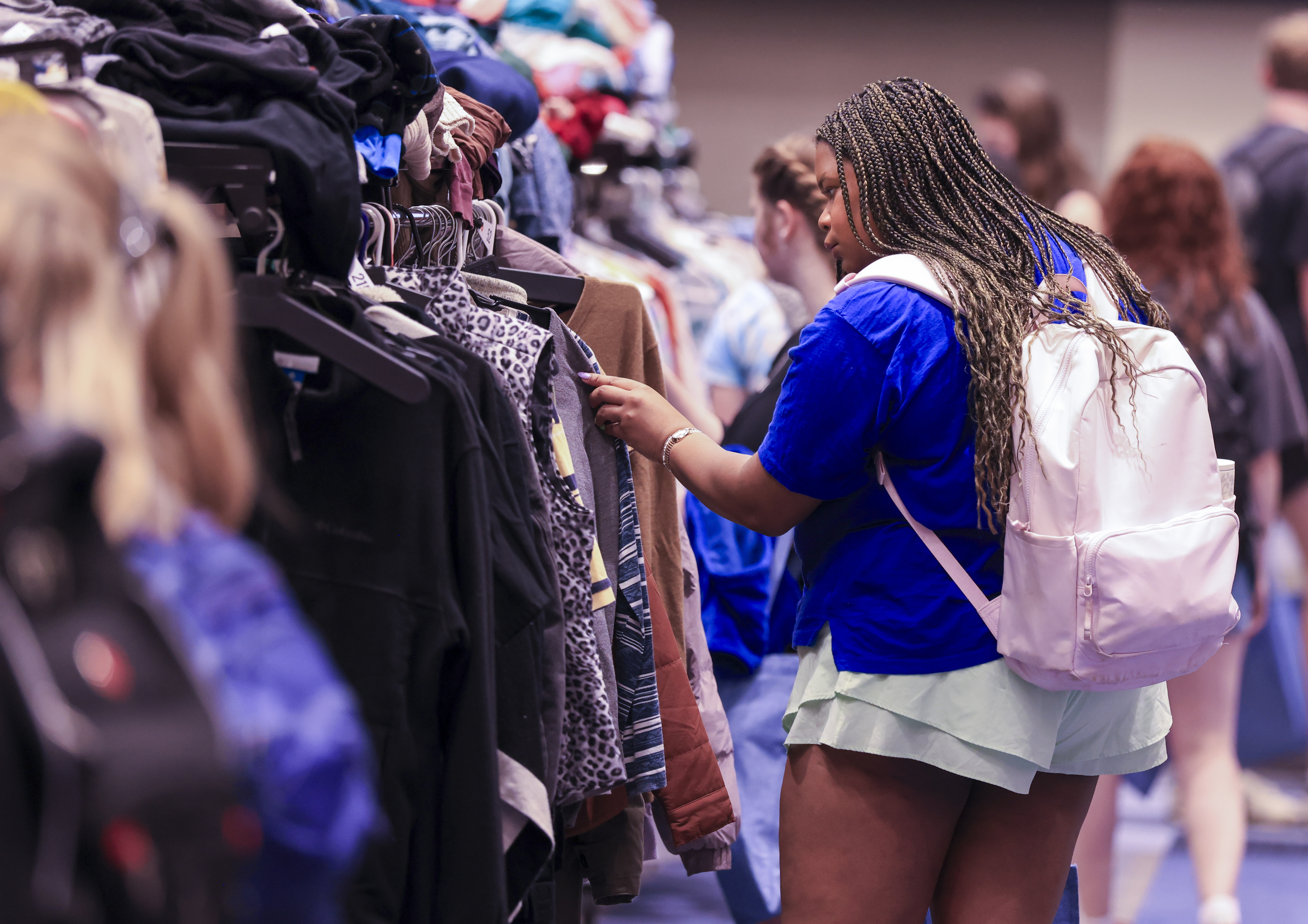 Students looking at clothes at the Thrift Shop Pop Up