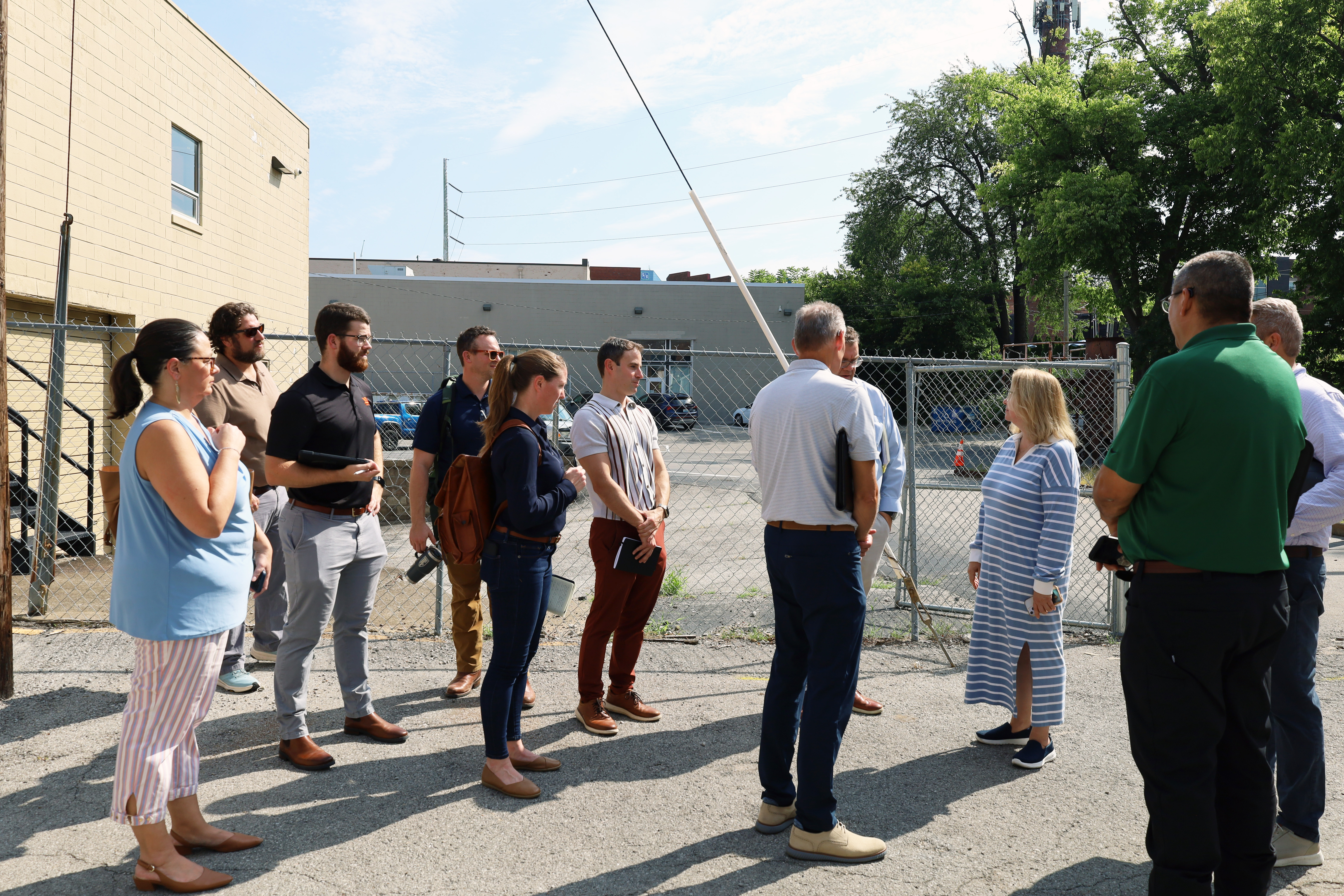 A group of people standing outside by buildings