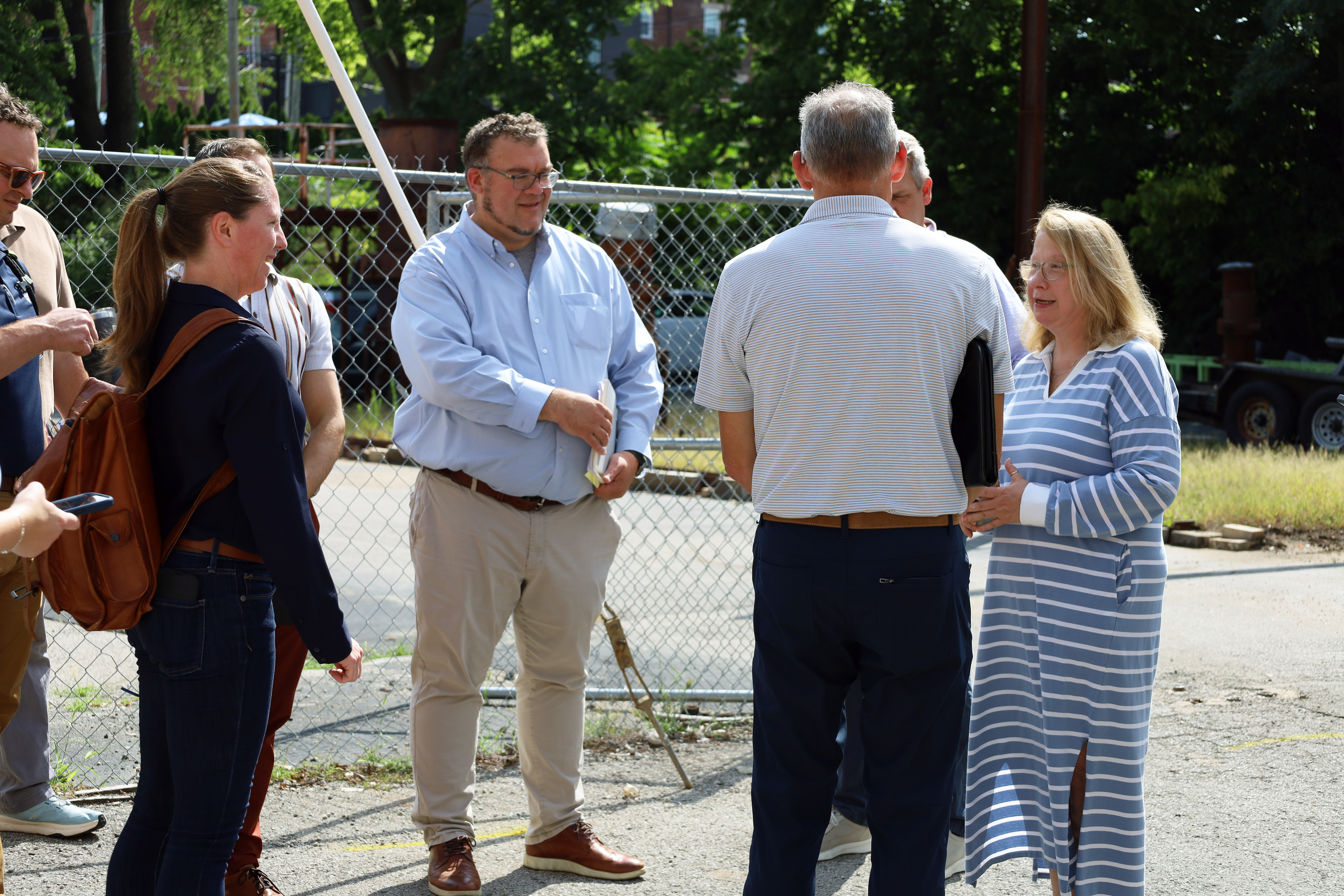 A group of people standing outside in a parking lot