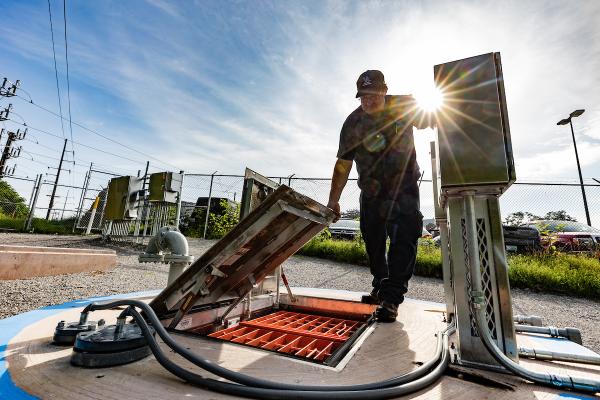 Facilities employee working on stormwater harvesting system.