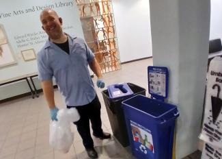 Man emptying a trash bin
