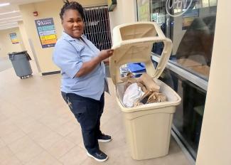 Woman takes trash out of bin