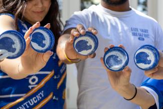 Students showing off game day buttons