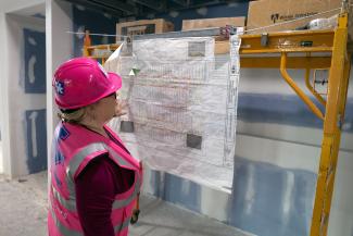 One woman looks at construction map at renovation site