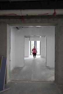 One woman walking through construction site at the White Hall Classroom Building renovation