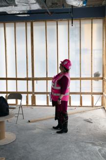 One woman looking at area where windows will go in White Hall Classroom Building renovation site