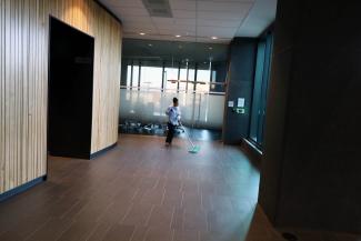 A woman sweeps an entrance