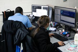 Two Controls Engineering team members work on computers