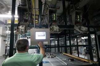 Man using controls for pneumatic tube system