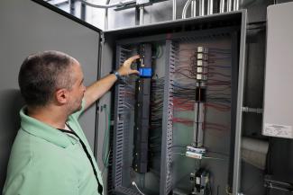 Controls Engineering team member working at panel