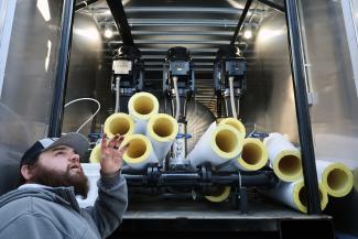 A person standing in front of the rental deaerator tank