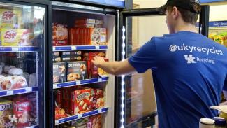 A student takes a frozen meal out of a freezer in the Wildcat Pantry