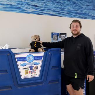 UK Student donating a teddy bear during the semi-annual Give & Go Donations.