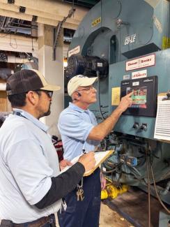 Two maintenance workers in the Pav A mechanical room