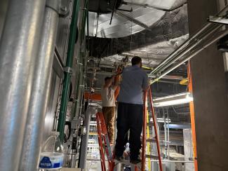 Two men work on steam in Chandler Hospital Pavilion A
