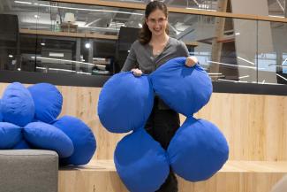 Student holding a piece of the modular chair