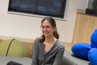 Student sitting smiling at camera