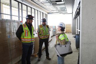Shareese Malone speaks with contractors at the renovation of the White Hall Classroom Building