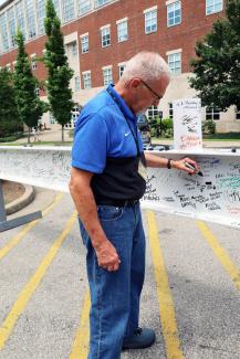 man signing construction beam