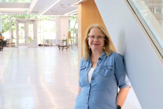 Sandy Redmon standing in Scovell Hall on near the first floor stairs