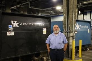 Tim Meyers standing by landfill and recycling compactors