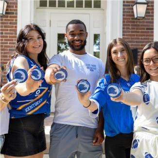 UK College of Education student ambassadors posing with one of the Nobody Recycles Like BBN buttons.