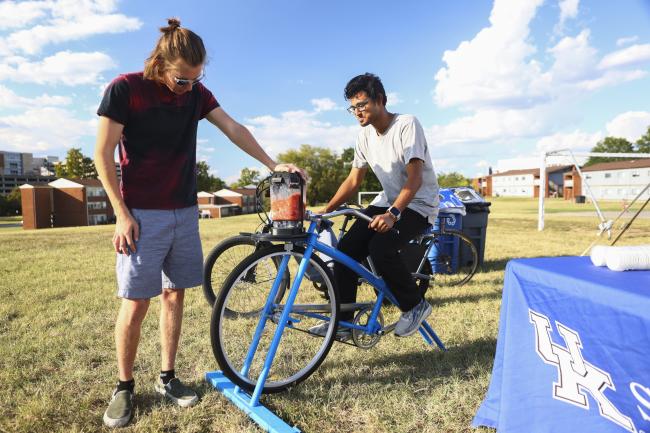 UK Student making a smoothie on the smoothie bike at the Sustainability Festival.