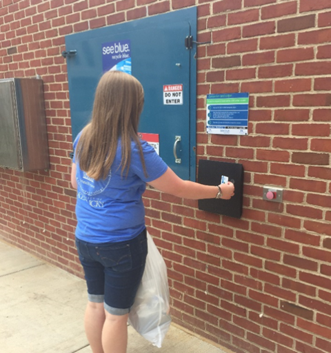 An image of a student unlocking the compactor doors 