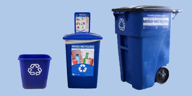 Three blue recycling bins