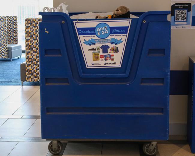 A large blue bin for collecting donations in the residence hall lobbies.