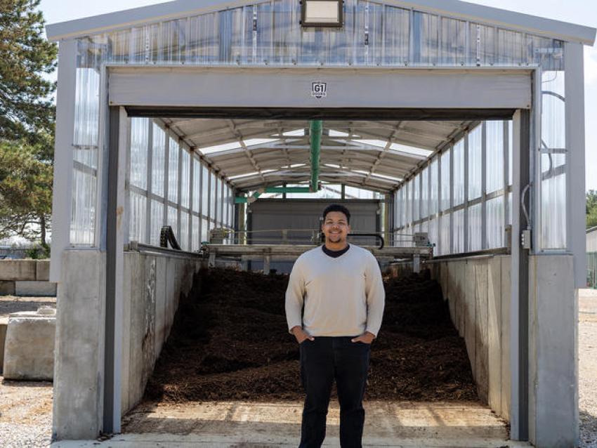 Jacob Hampton, a student, standing outside the composting system.