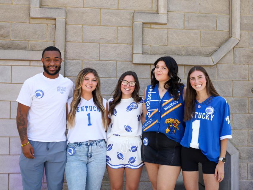 Students showing the first football game day button